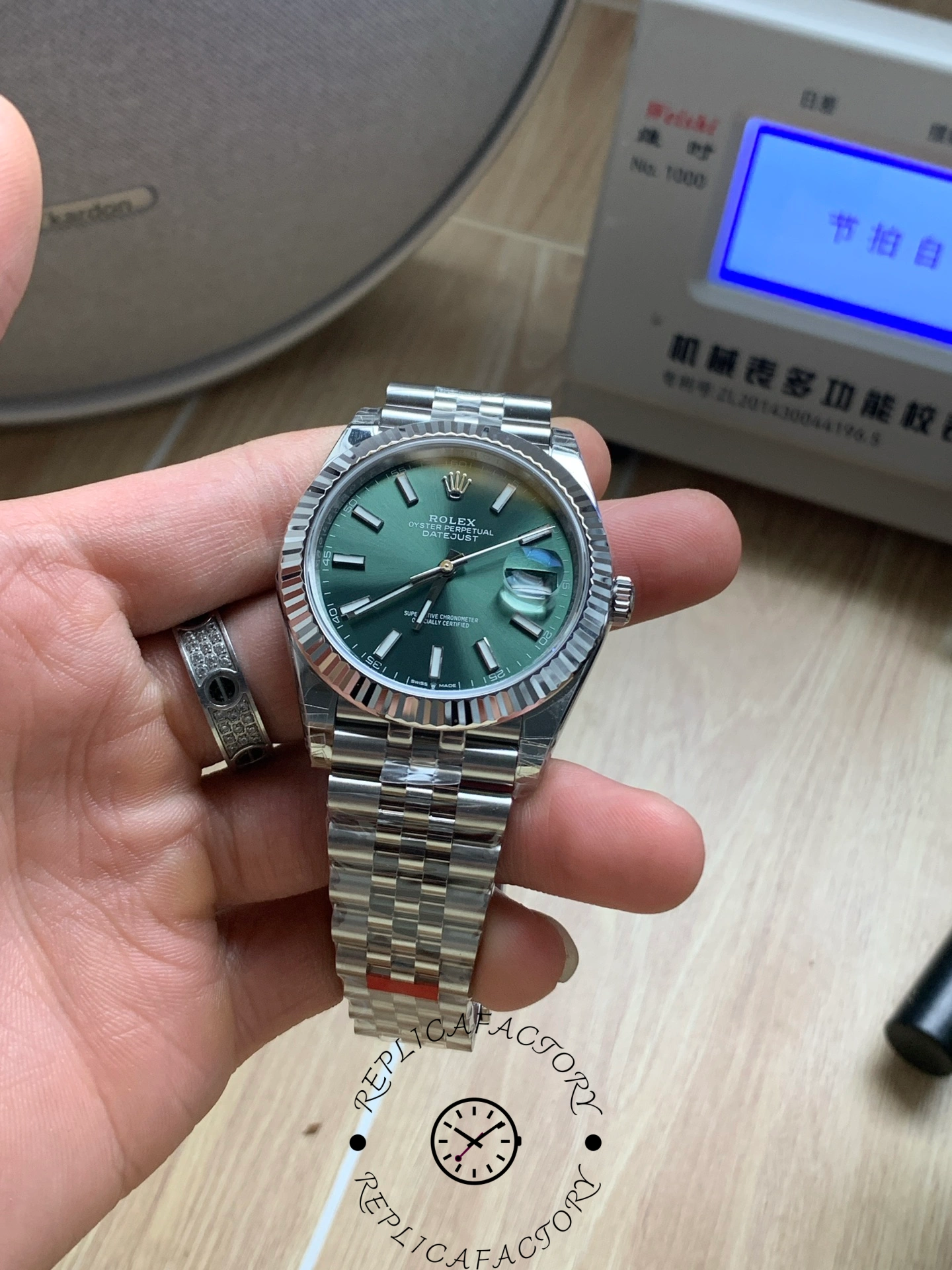 Straight-on view of the Rolex Datejust 126334-0028 with green dial and polished case.