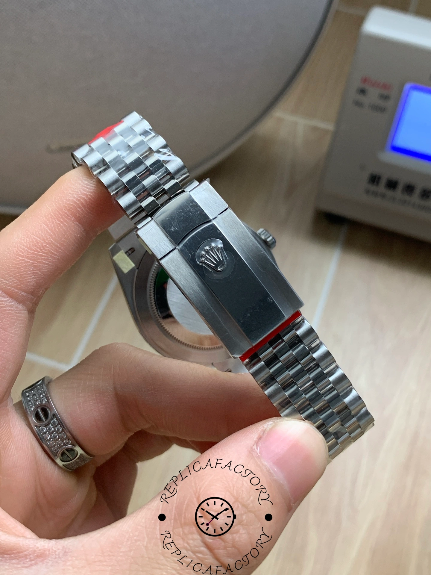 Side and clasp view of the Rolex Datejust 126334-0028 with protective stickers on the bracelet.