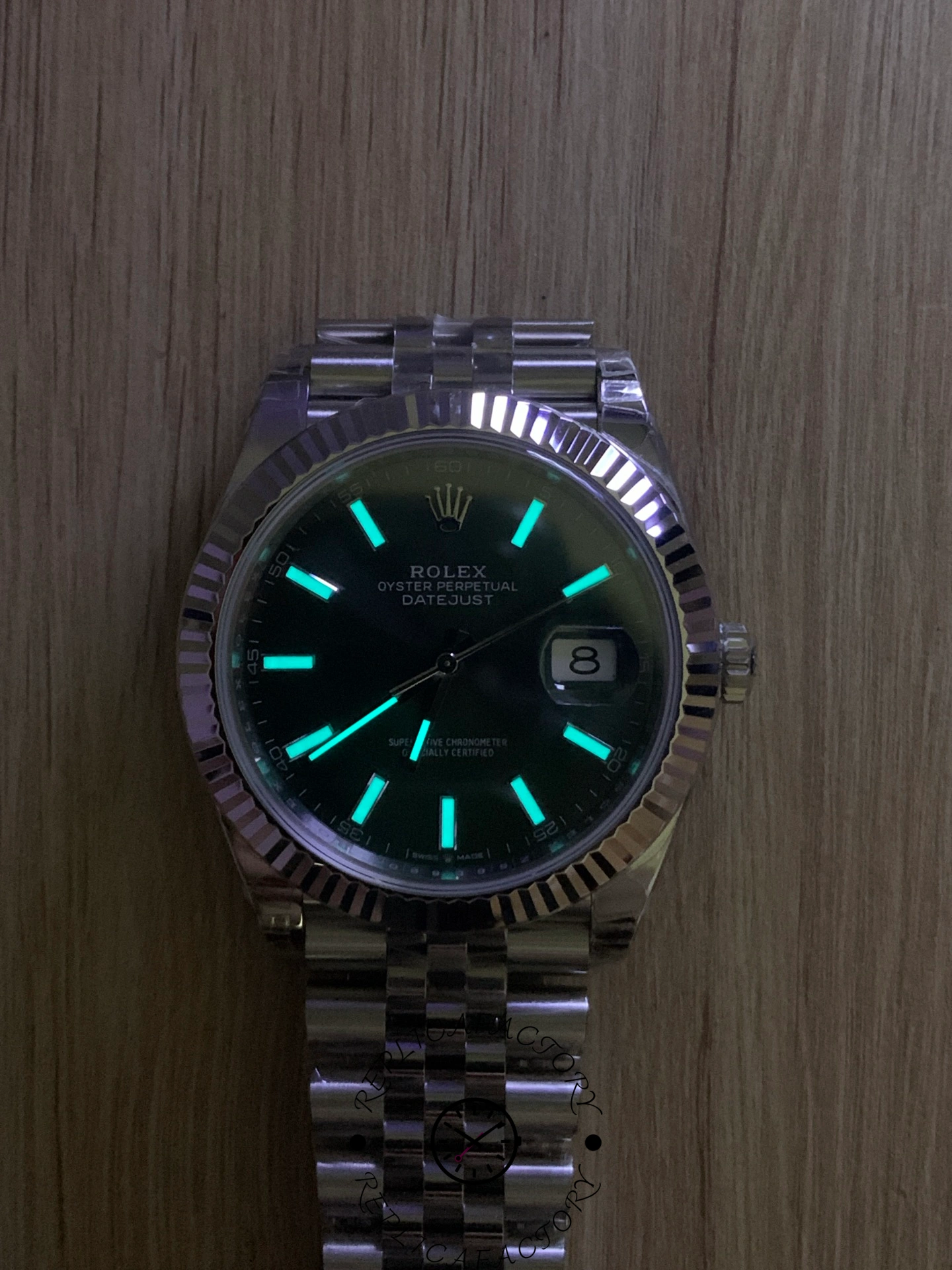 Lume shot of the Rolex Datejust 126334-0028 showing the glowing markers and hands on the dark dial.