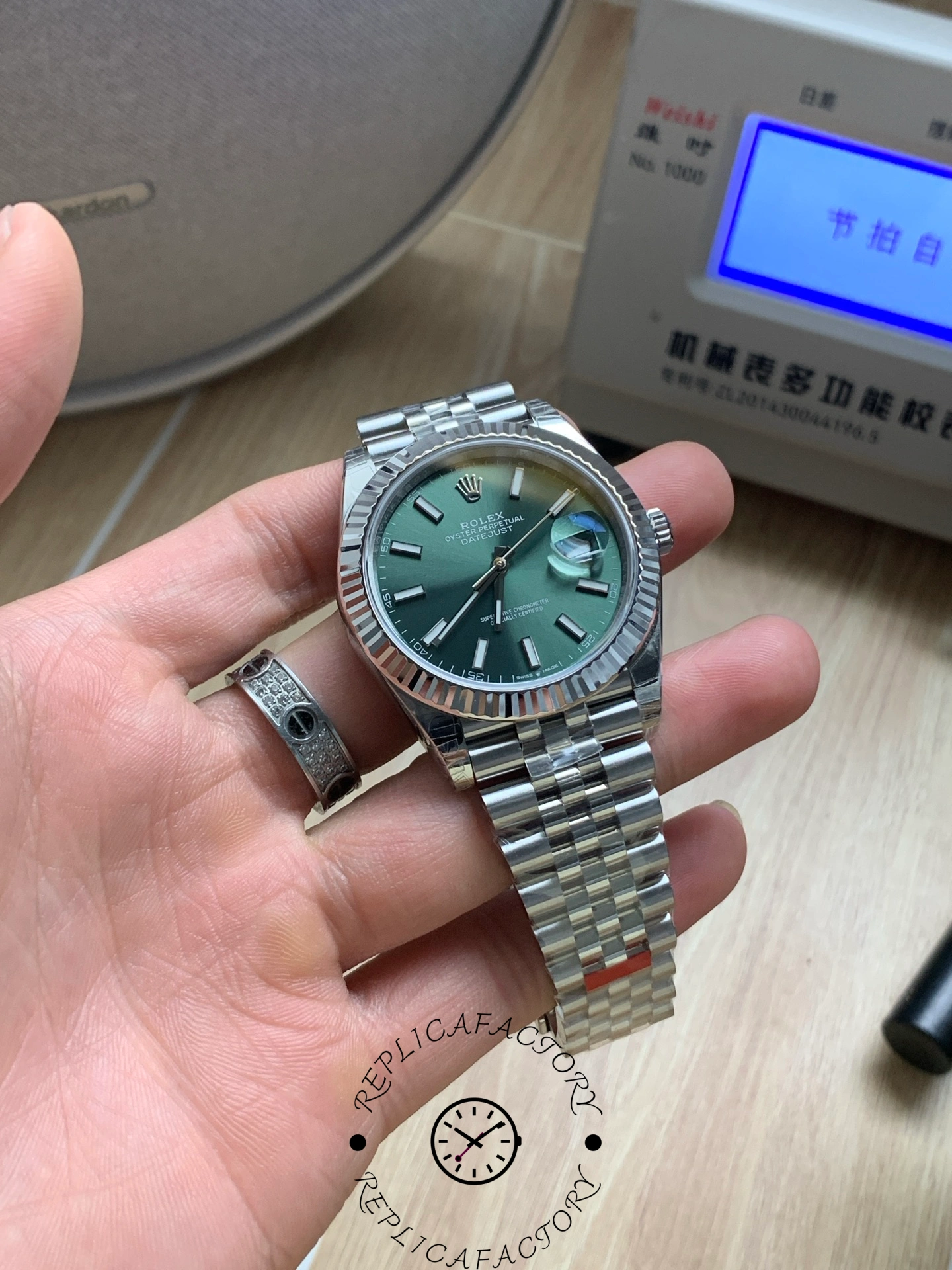 Angled front view of the Rolex Datejust 126334-0028 showing the green dial and fluted bezel.