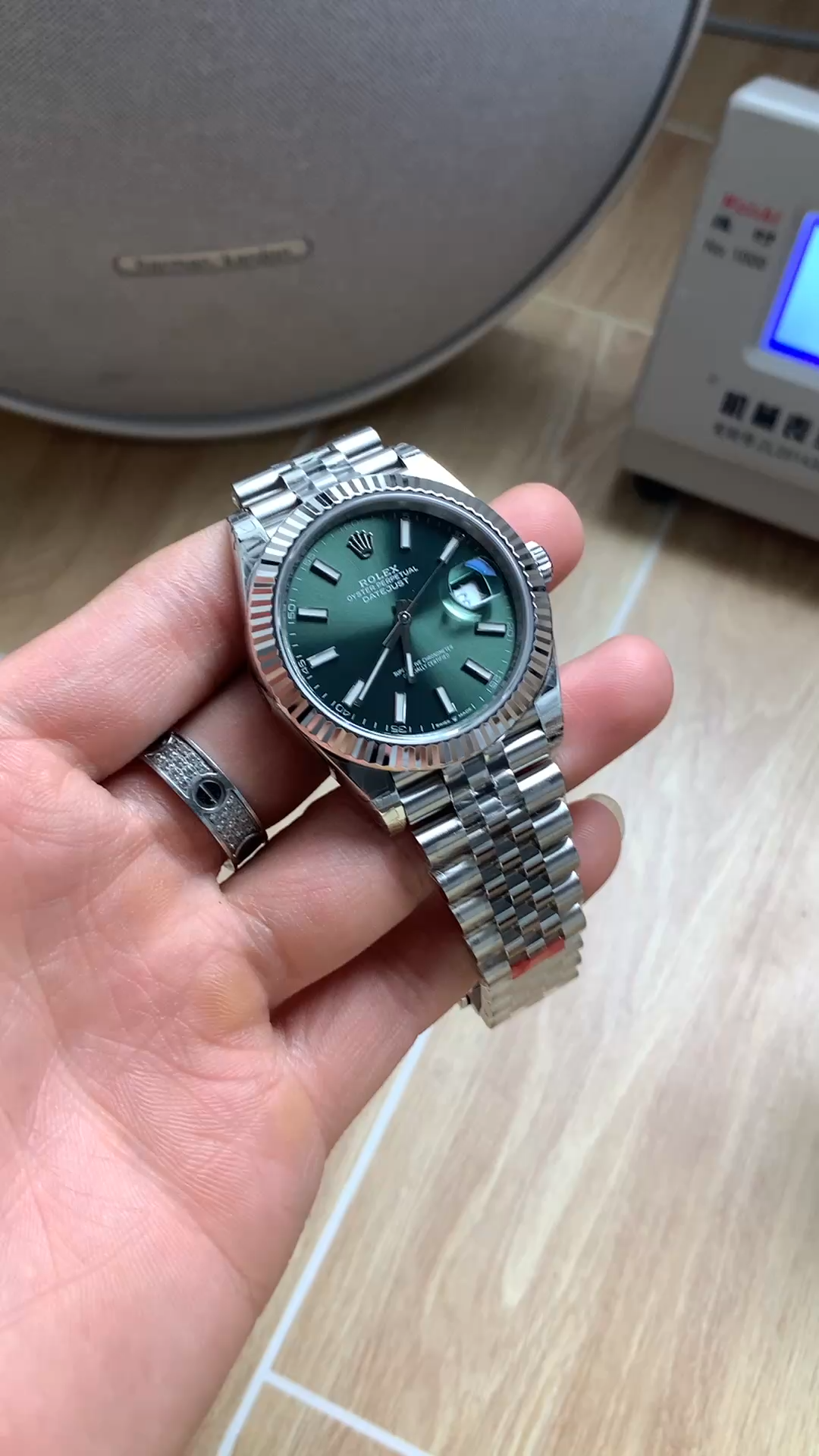 Handheld view of the Rolex Datejust 126334-0028 with green dial and Jubilee bracelet. - Video