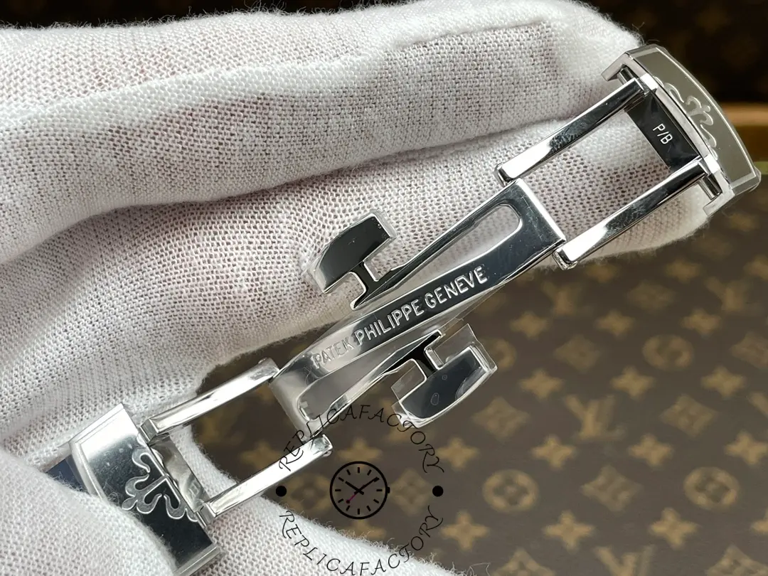 A close-up of the Patek Philippe Aquanaut 5168G-001 with the clasp open, revealing the 904L stainless steel folding clasp.