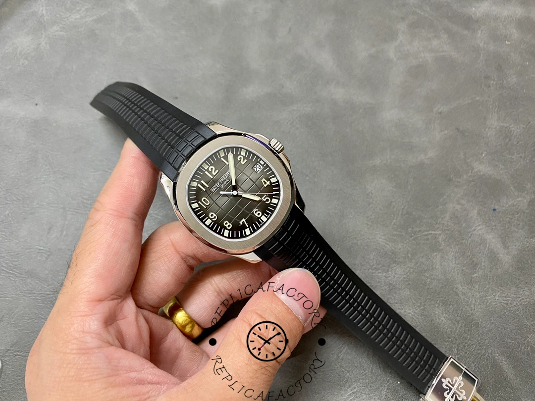 Hand-held full angle of Patek Philippe Aquanaut 5167A-001 highlighting embossed dial pattern.