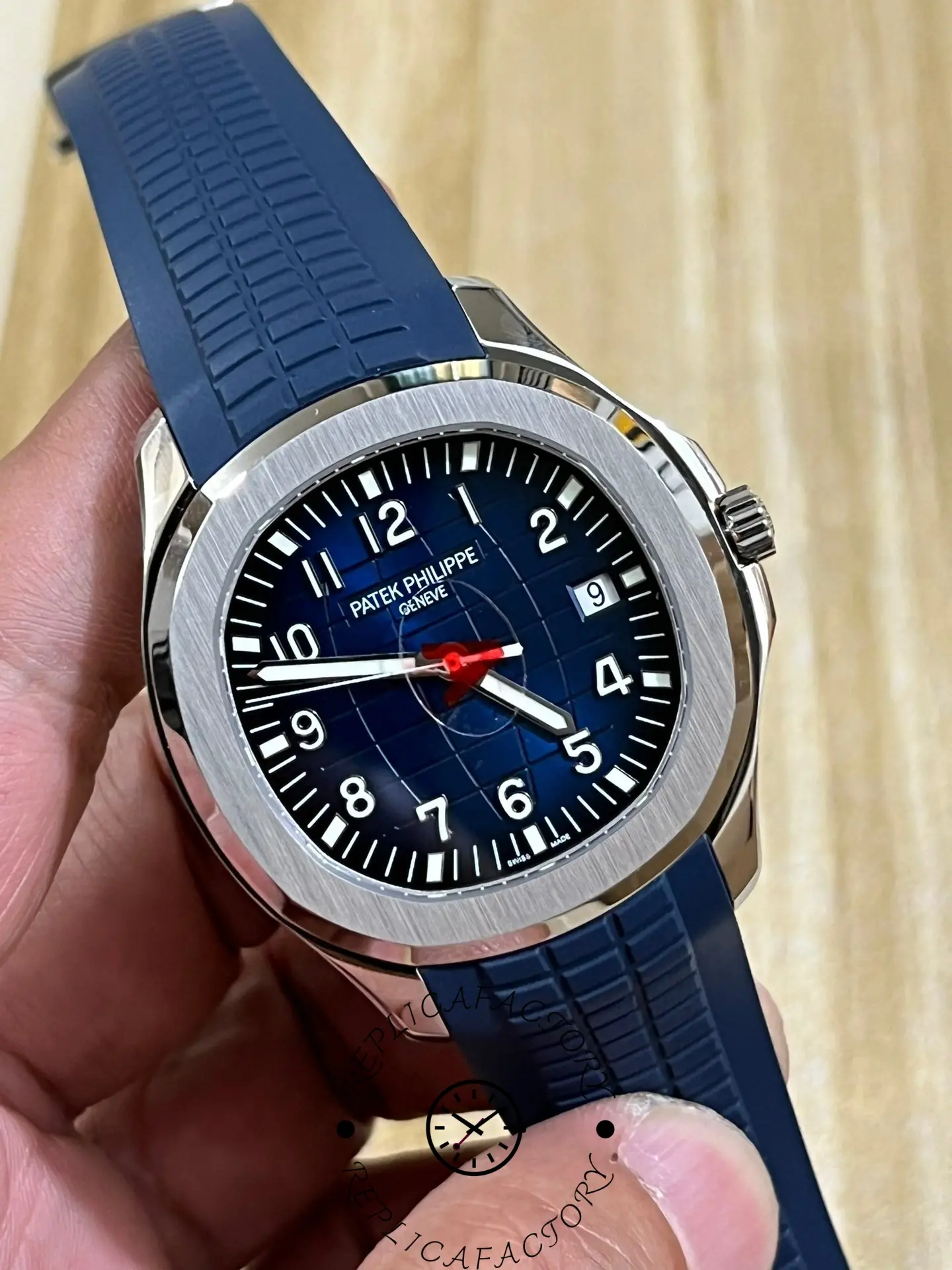 Another angled photo of the Patek Philippe Aquanaut 5168G-001, taken handheld, shows the sunburst blue-black-gradient dial.