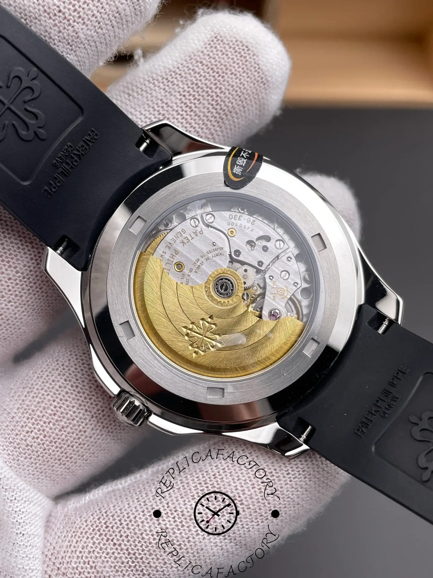 Exhibition caseback of Patek Philippe Aquanaut 5167A-001 showing gold rotor and movement finishing.