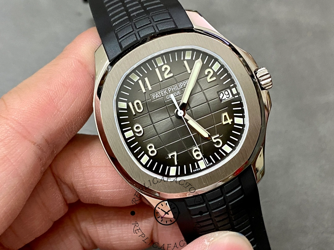 Hand-held front angle of Patek Philippe Aquanaut 5167A-001 highlighting embossed dial pattern.