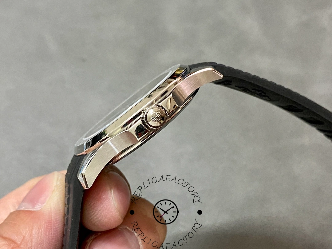 Side angle in hand of Patek Philippe Aquanaut 5167A-001 showing crown and case side finishing.