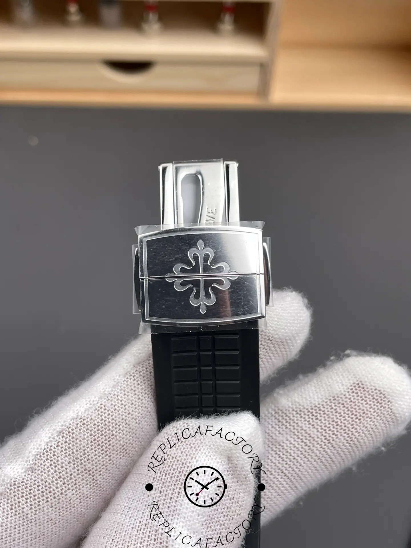 Deployant clasp detail of Patek Philippe Aquanaut 5167A-001 showing clasp mechanism and logo.