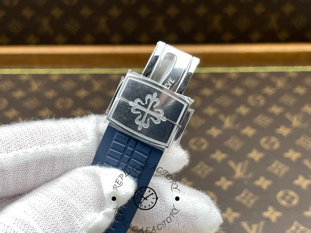 A close-up of the Patek Philippe Aquanaut 5168G-001 watch strap buckle, showing the end of the buckle and the blue strap.