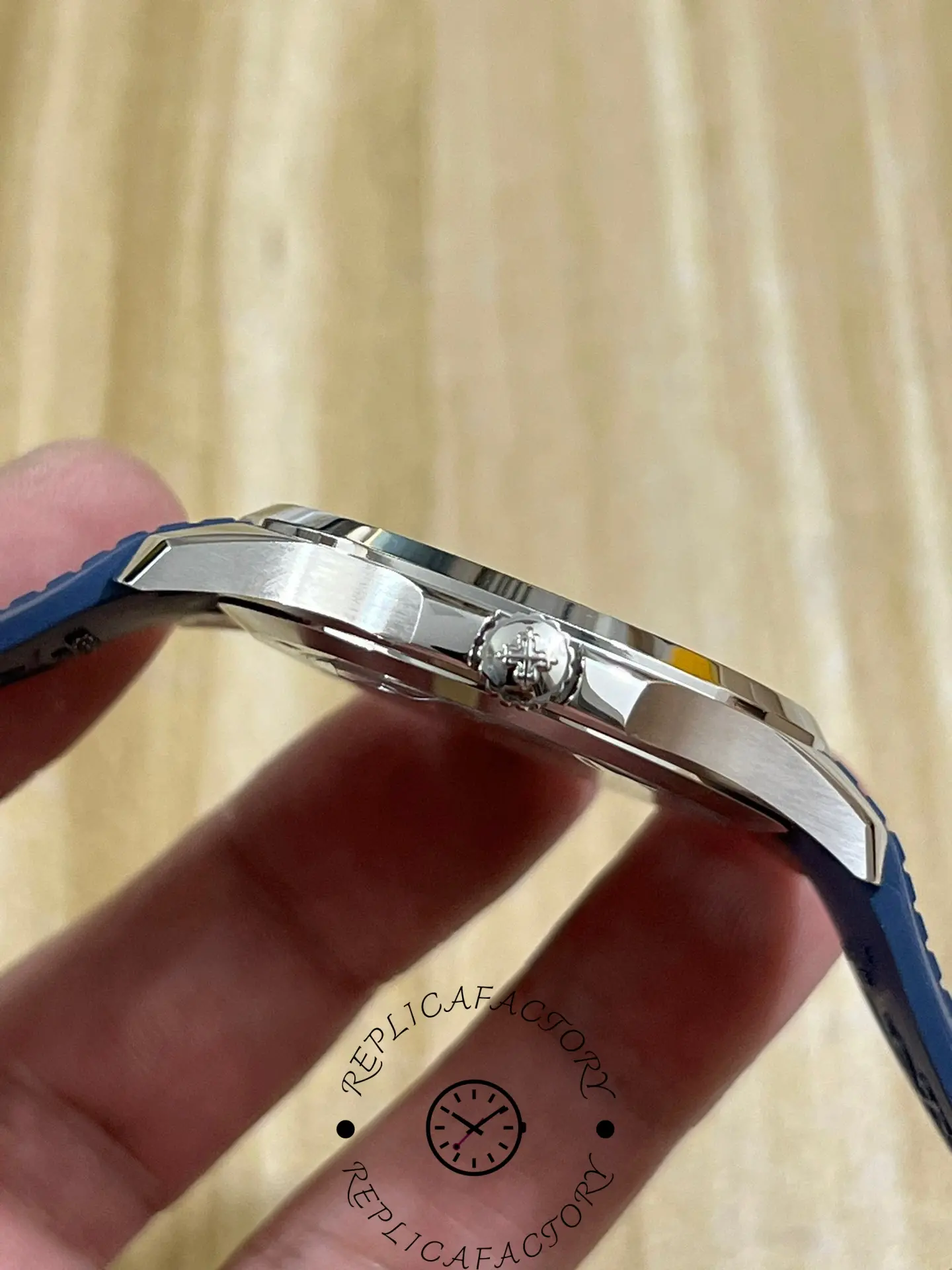 Side profile of Patek Philippe Aquanaut 5168G-001 showing crown, slim case and strap curvature.