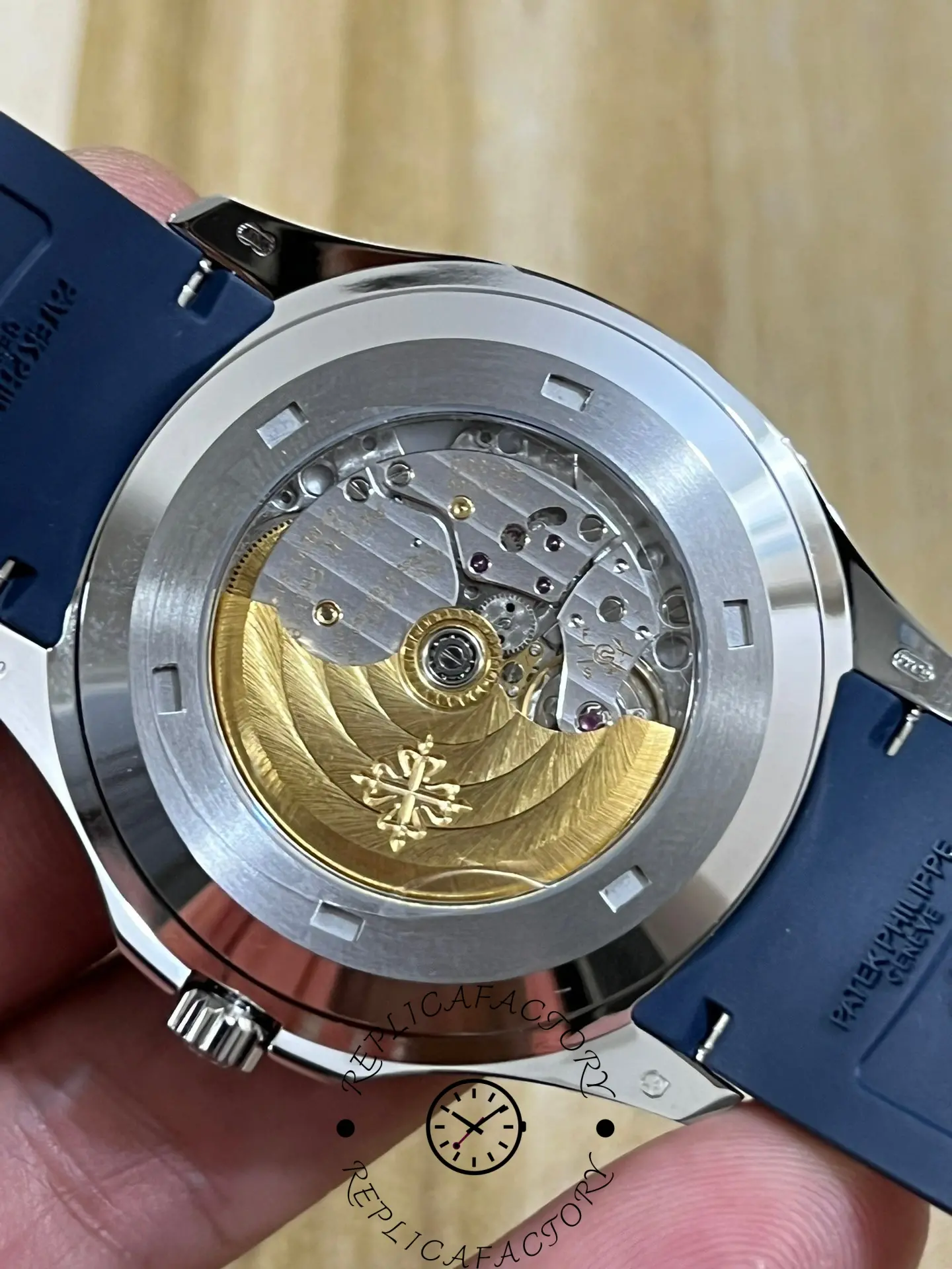 Caseback view of Patek Philippe Aquanaut 5168G-001 showing gold rotor and movement finishing.