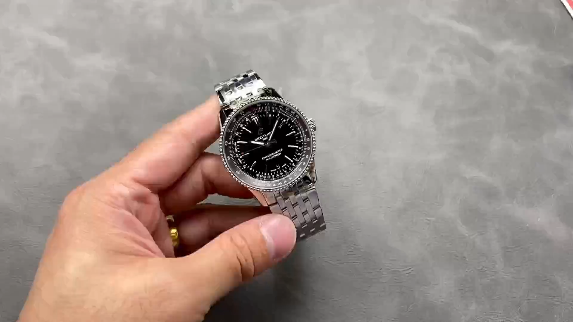 Hand-held view of Breitling Navitimer A17325241B1A1 showing dial and case profile.