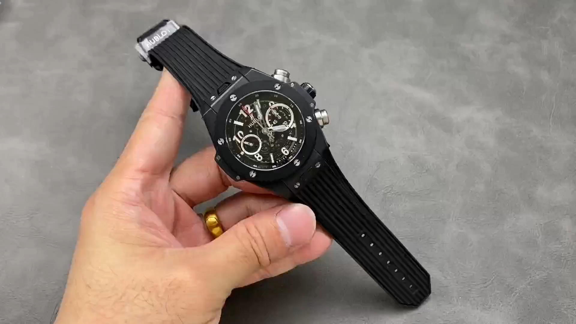 Strap in hand: Hublot Big Bang 411.CI.1170.RX showing black rubber strap laid out. - Video