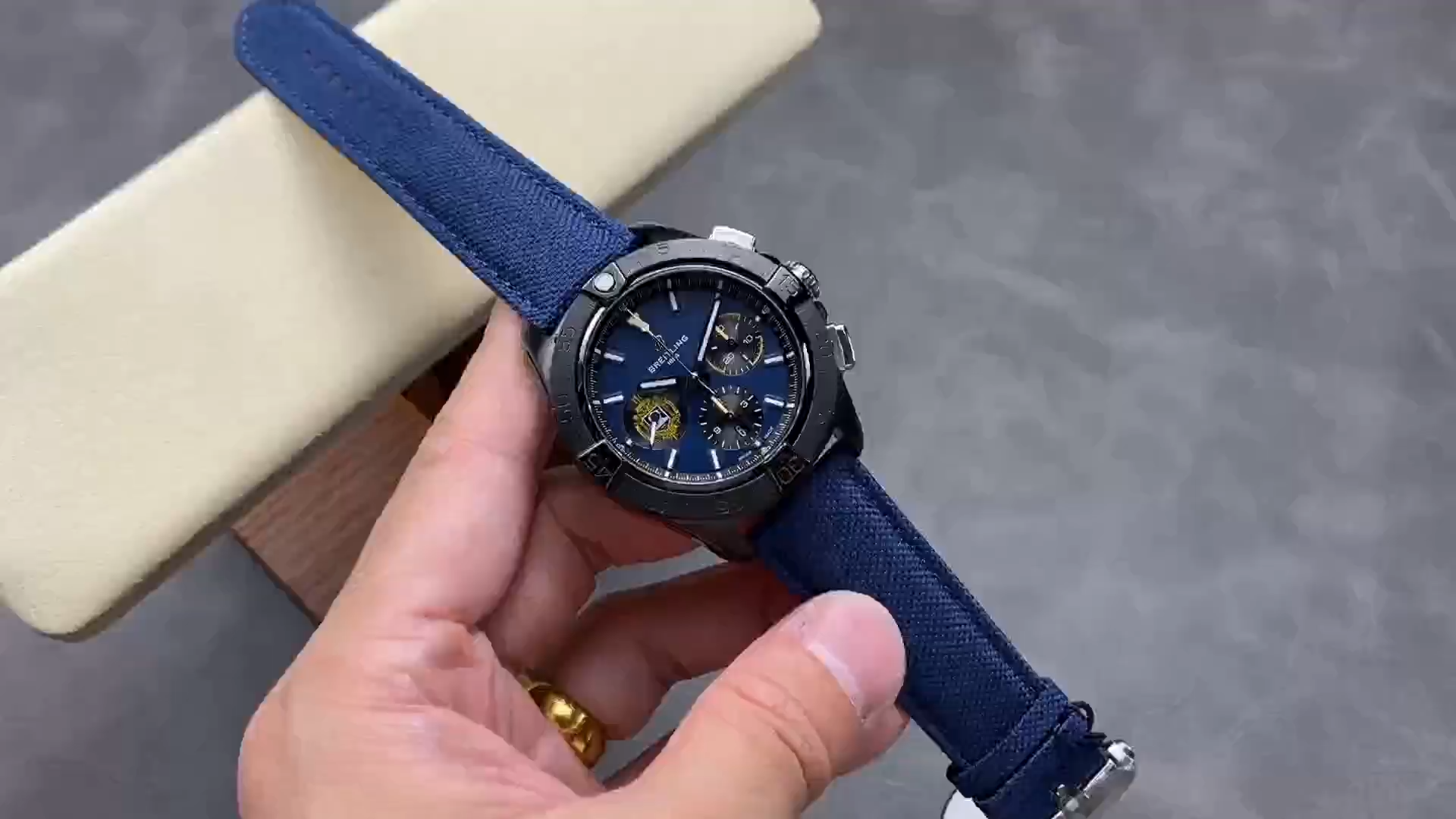 Hand-held view of Breitling Avenger Night Mission SB01474A1C1X1 showing blue strap and case profile. - Video