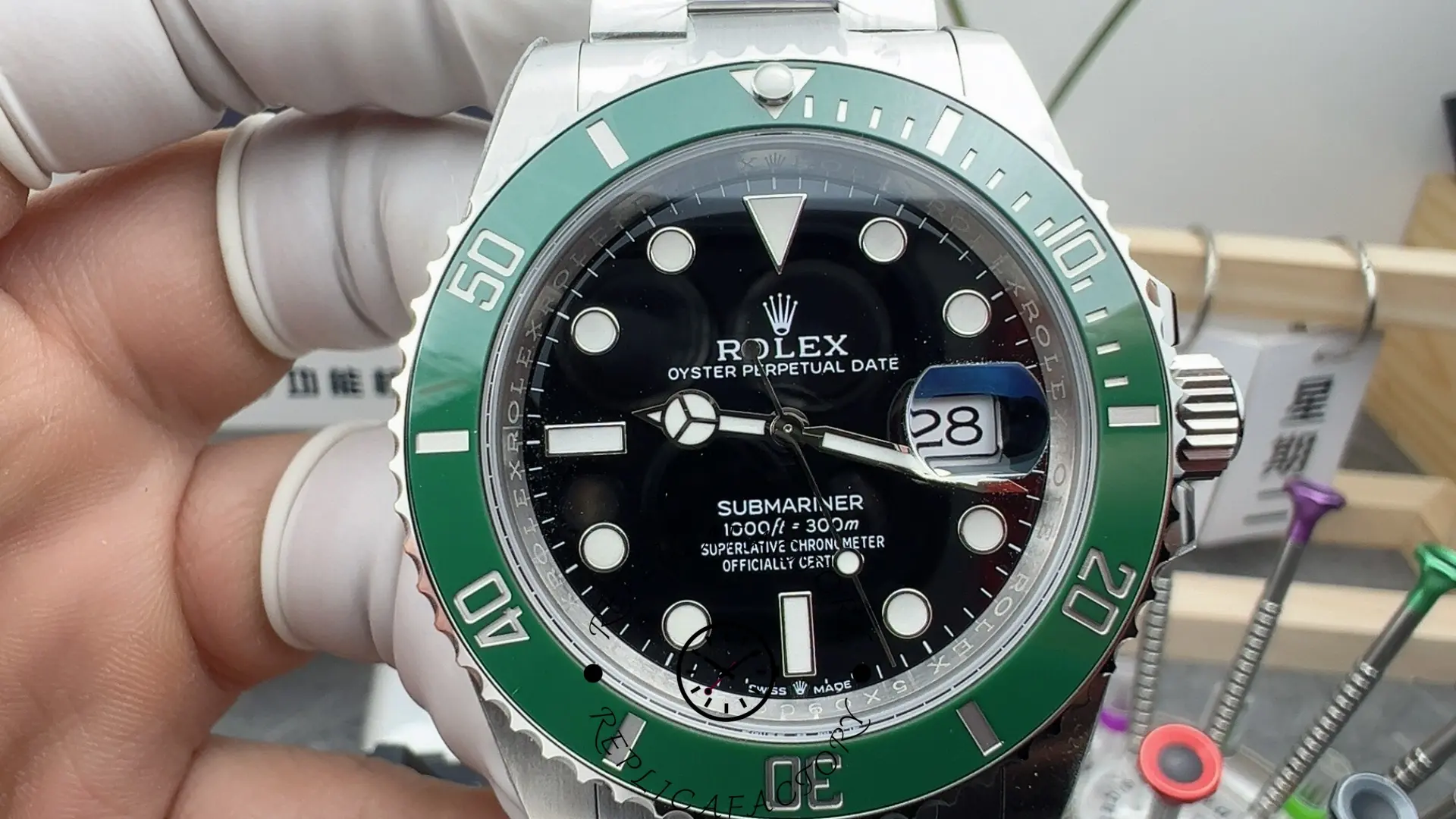 Rolex Submariner 126610LV, dial close-up showing date magnifier and green bezel minute markers.