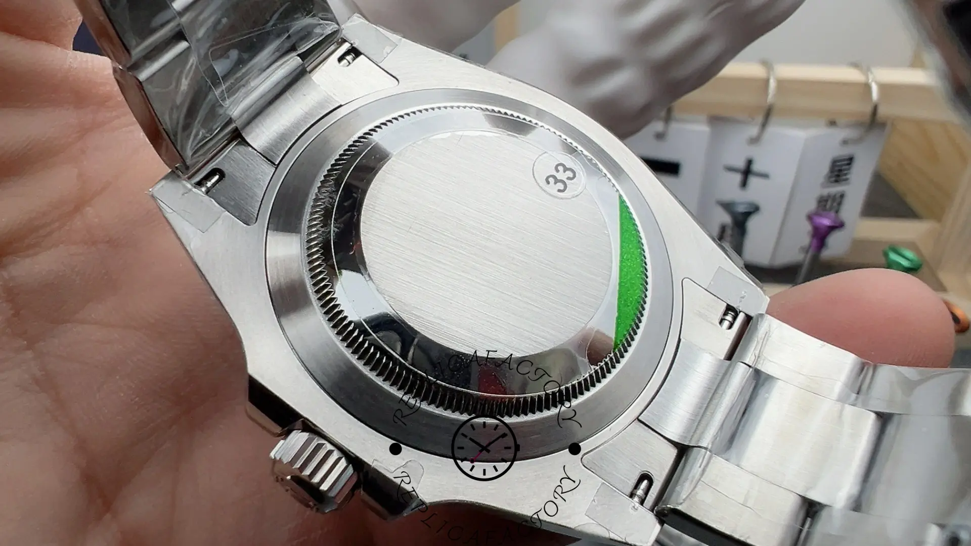 Rolex Submariner 126610LV, caseback sticker view with Oyster bracelet attached.