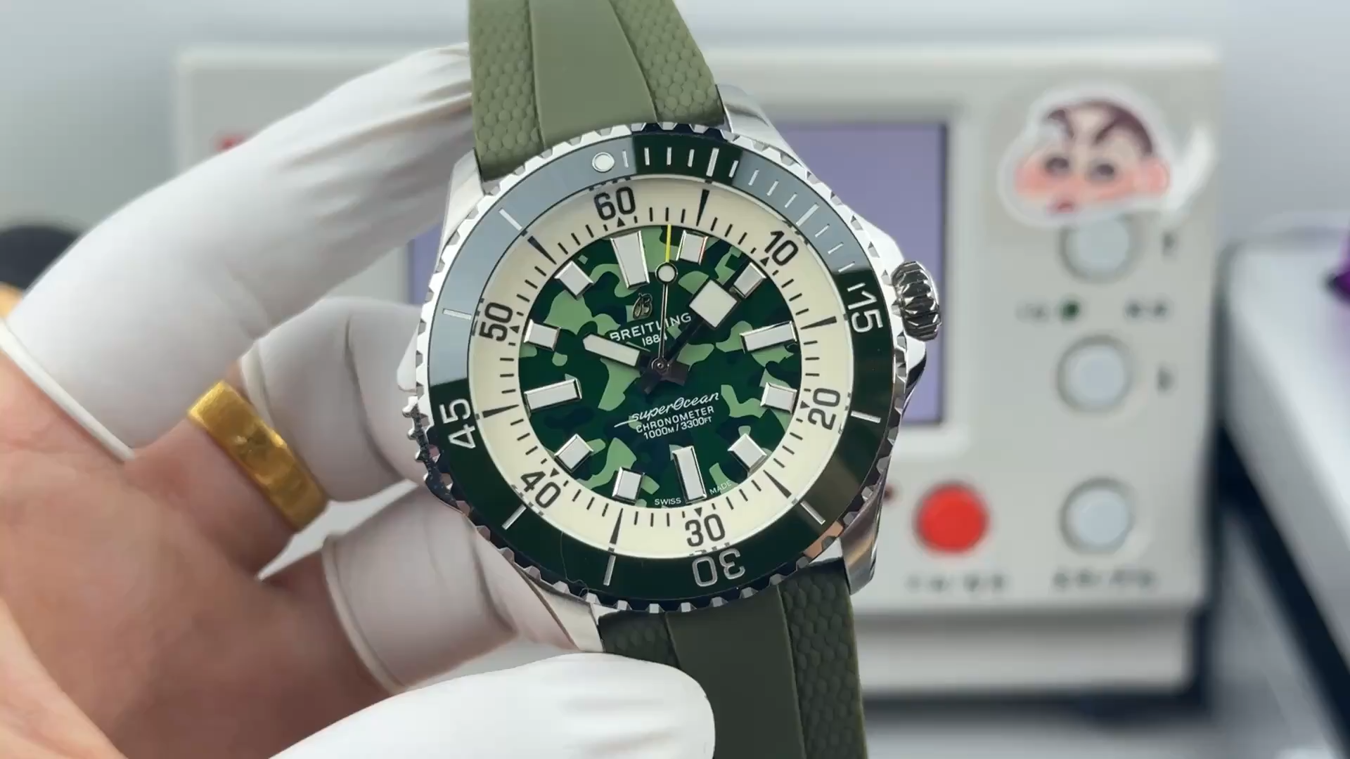 Video image of Breitling Superocean E10379D31L1S1 showing green camouflage dial and bezel markings. - Video