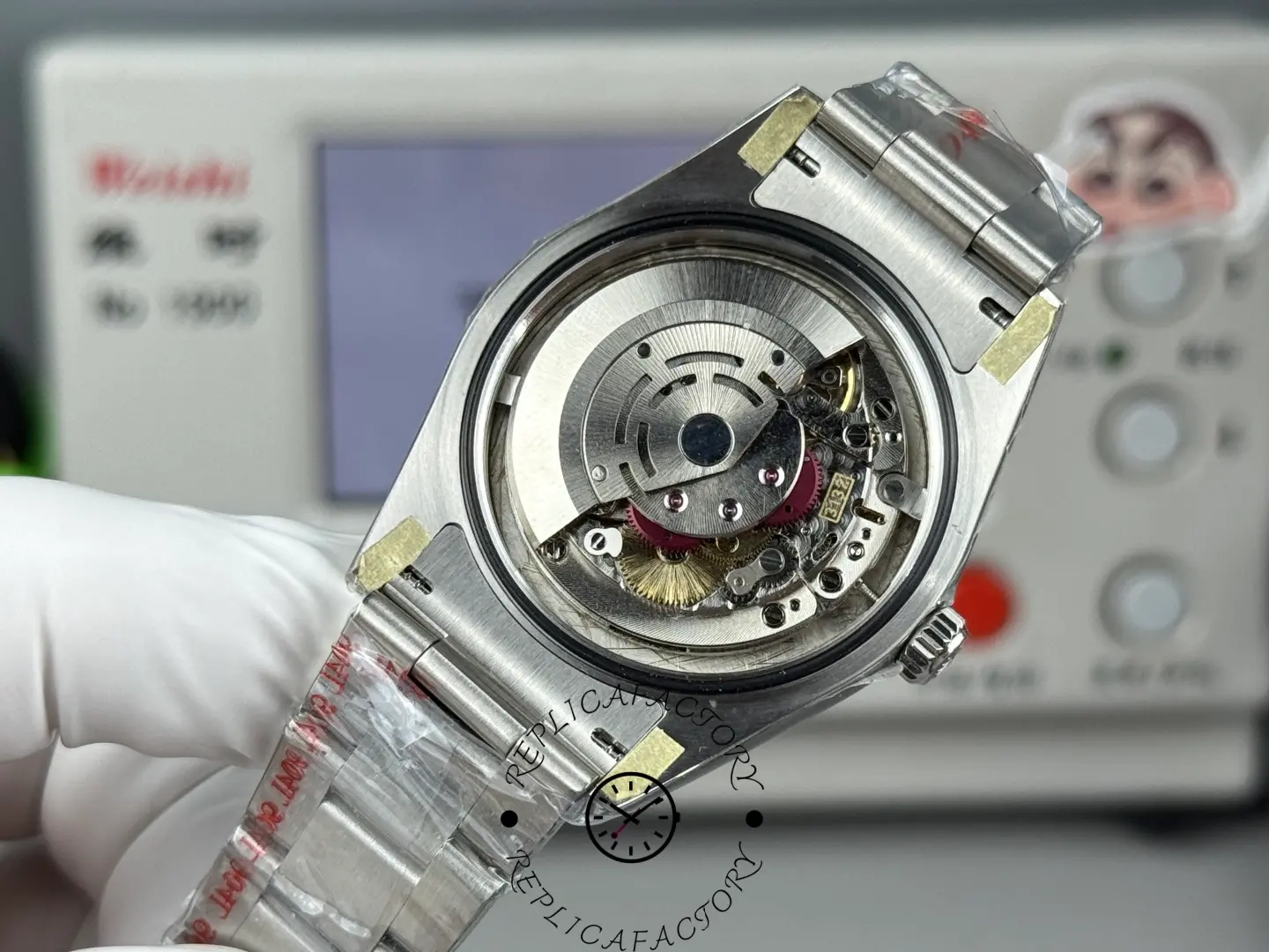 Rolex Air-King 126900 open case back showing movement rotor, stainless steel bracelet.