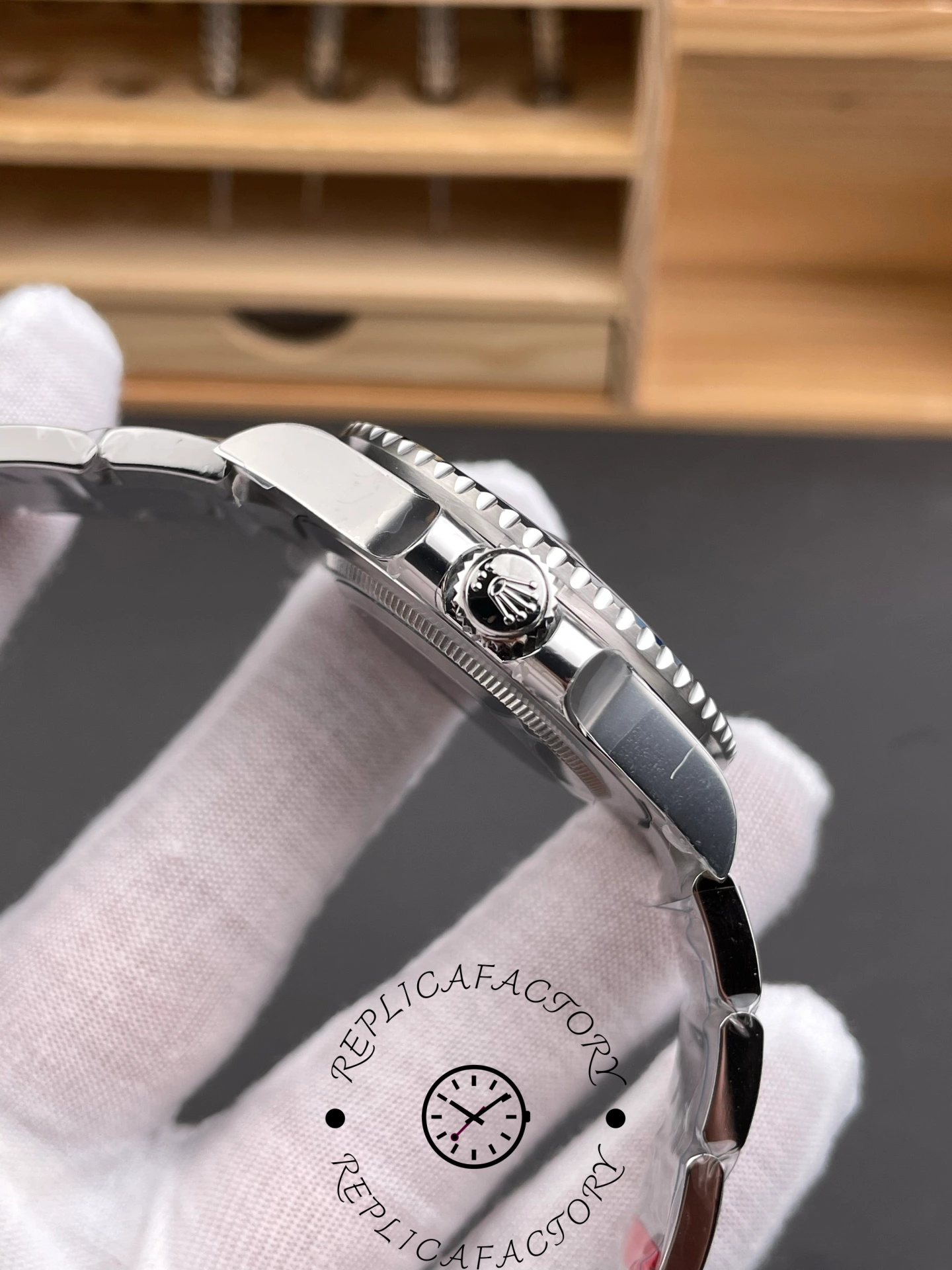 Rolex GMT-Master II 126710BLNR 0003 side profile, crown and bezel edge, in glove.