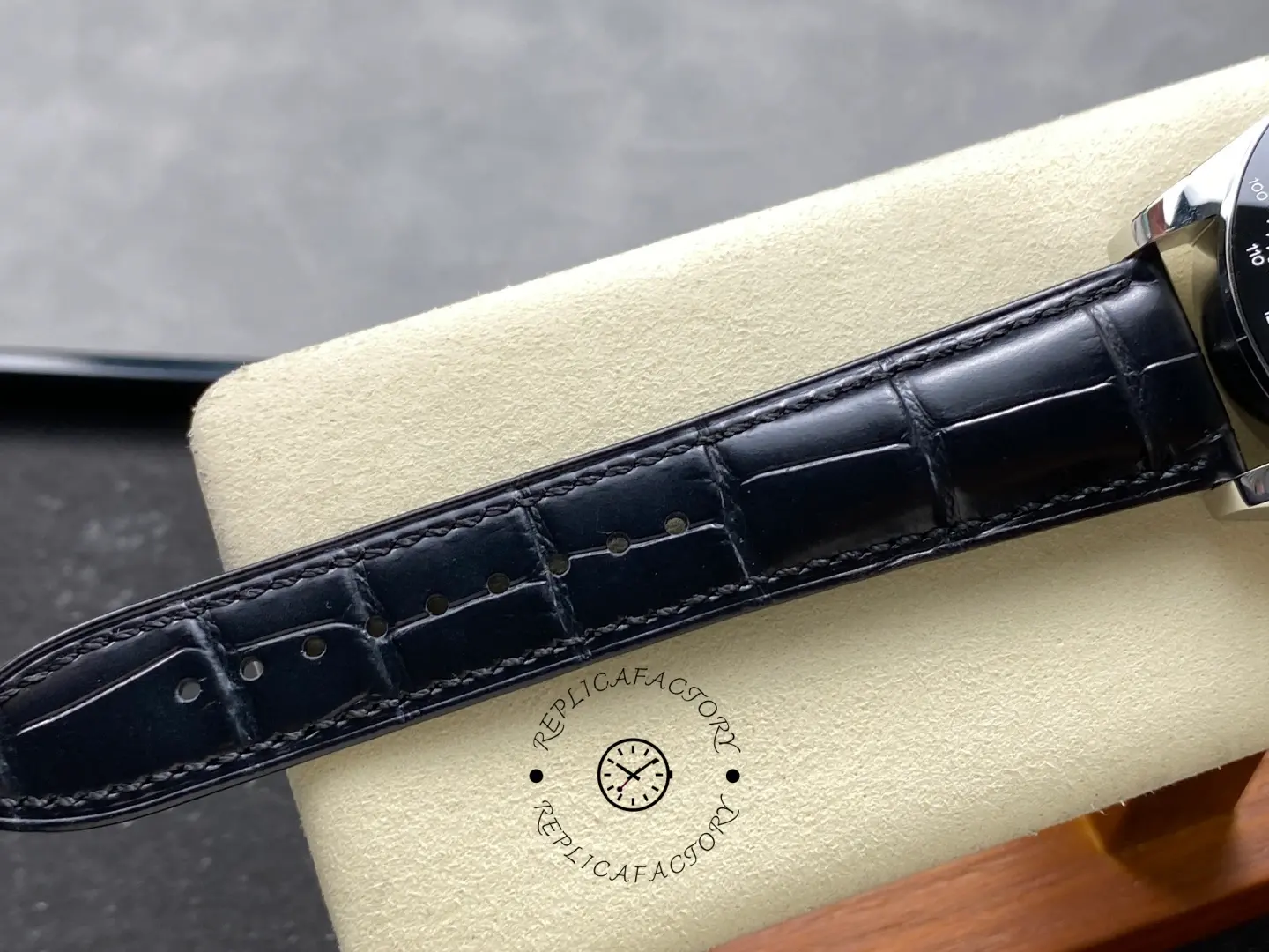 Longines Conquest Chronograph L3.835.4.72.6, close-up of black leather strap with alligator pattern.