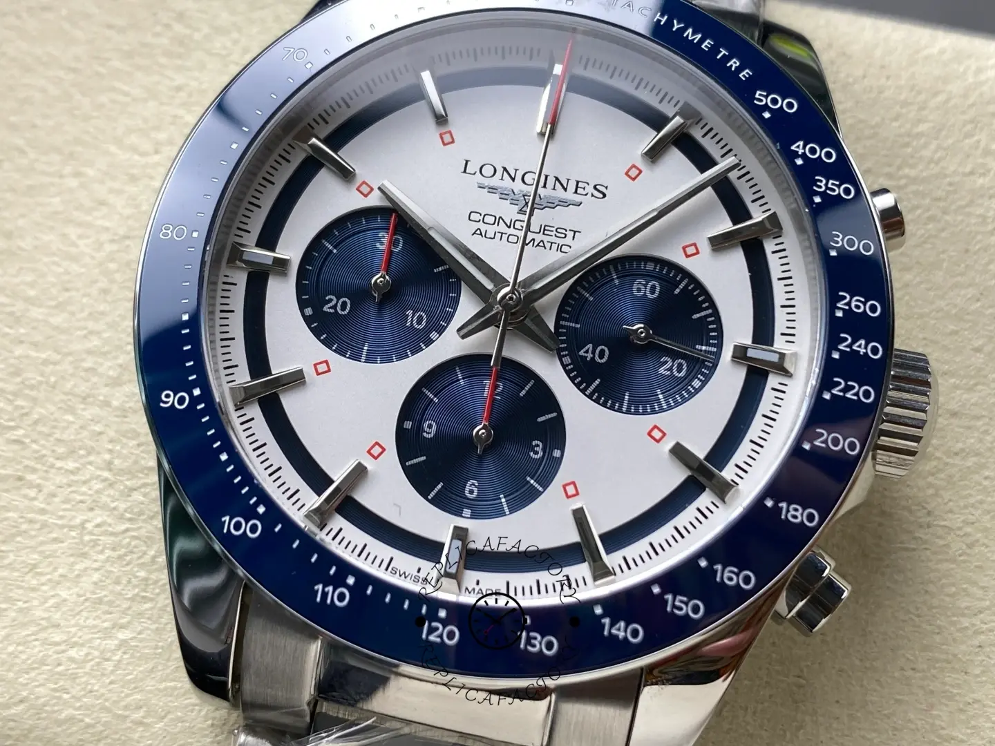Longines Conquest Chronograph L3.835.4.98.6, dial close-up showing three blue subdials, red accents, and baton markers.