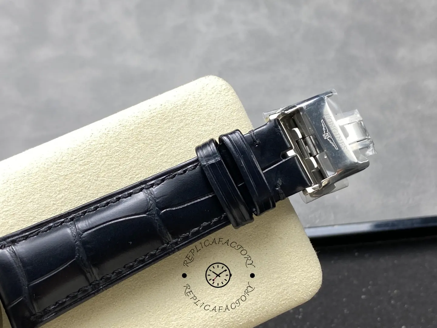 Longines Conquest Chronograph L3.835.4.98.9, clasp detail of black leather strap with Longines engraving.