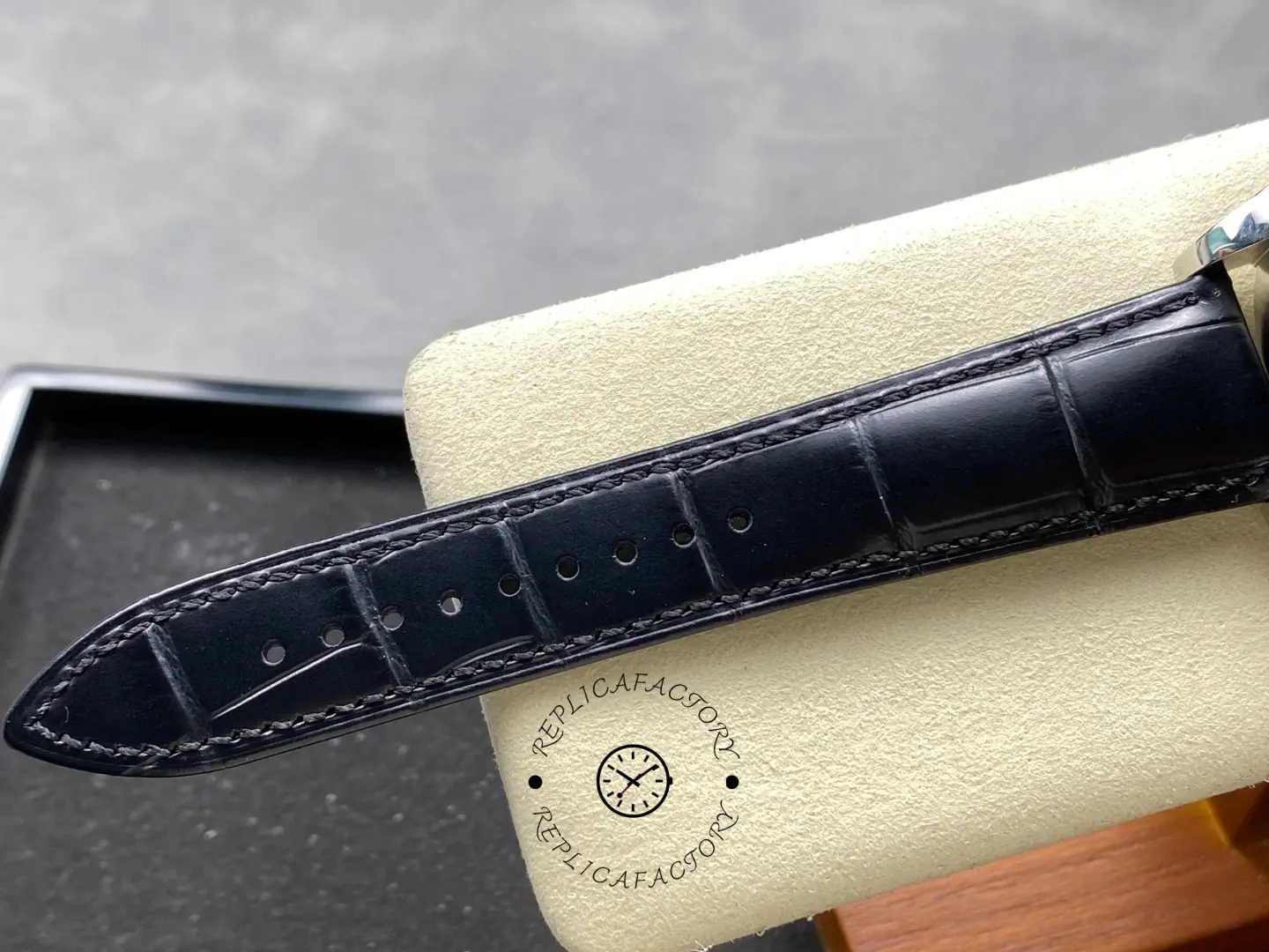 Black leather strap close-up of Longines Conquest L3.835.4.91.2 showing stitching and holes.