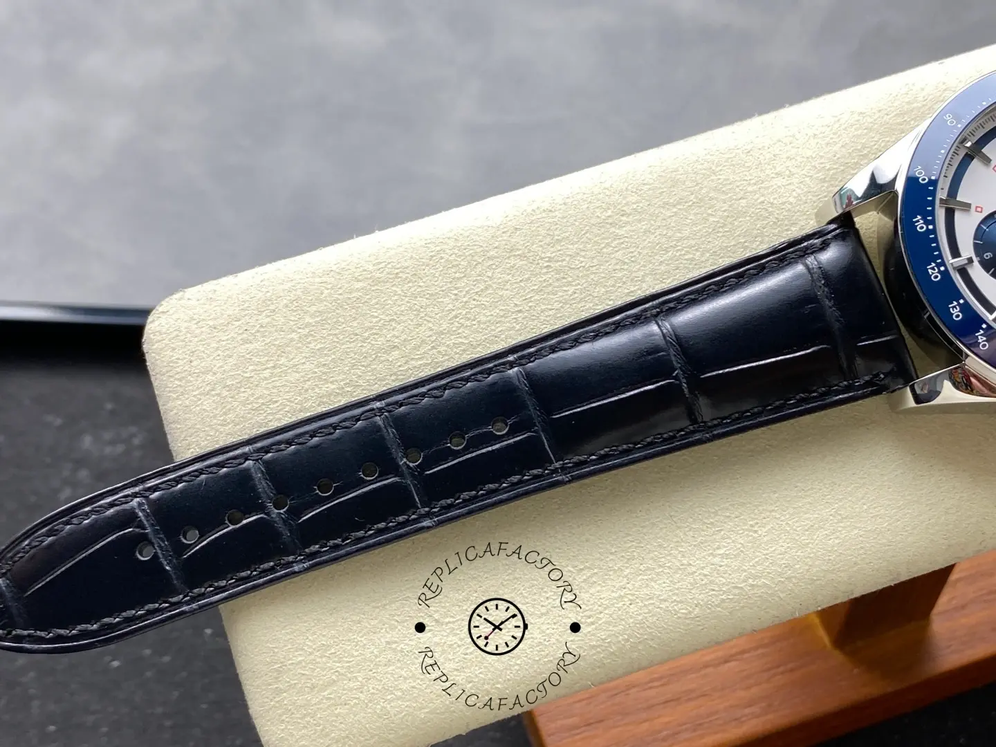 Longines Conquest Chronograph L3.835.4.98.9, close-up of black leather strap with alligator pattern and stitching.