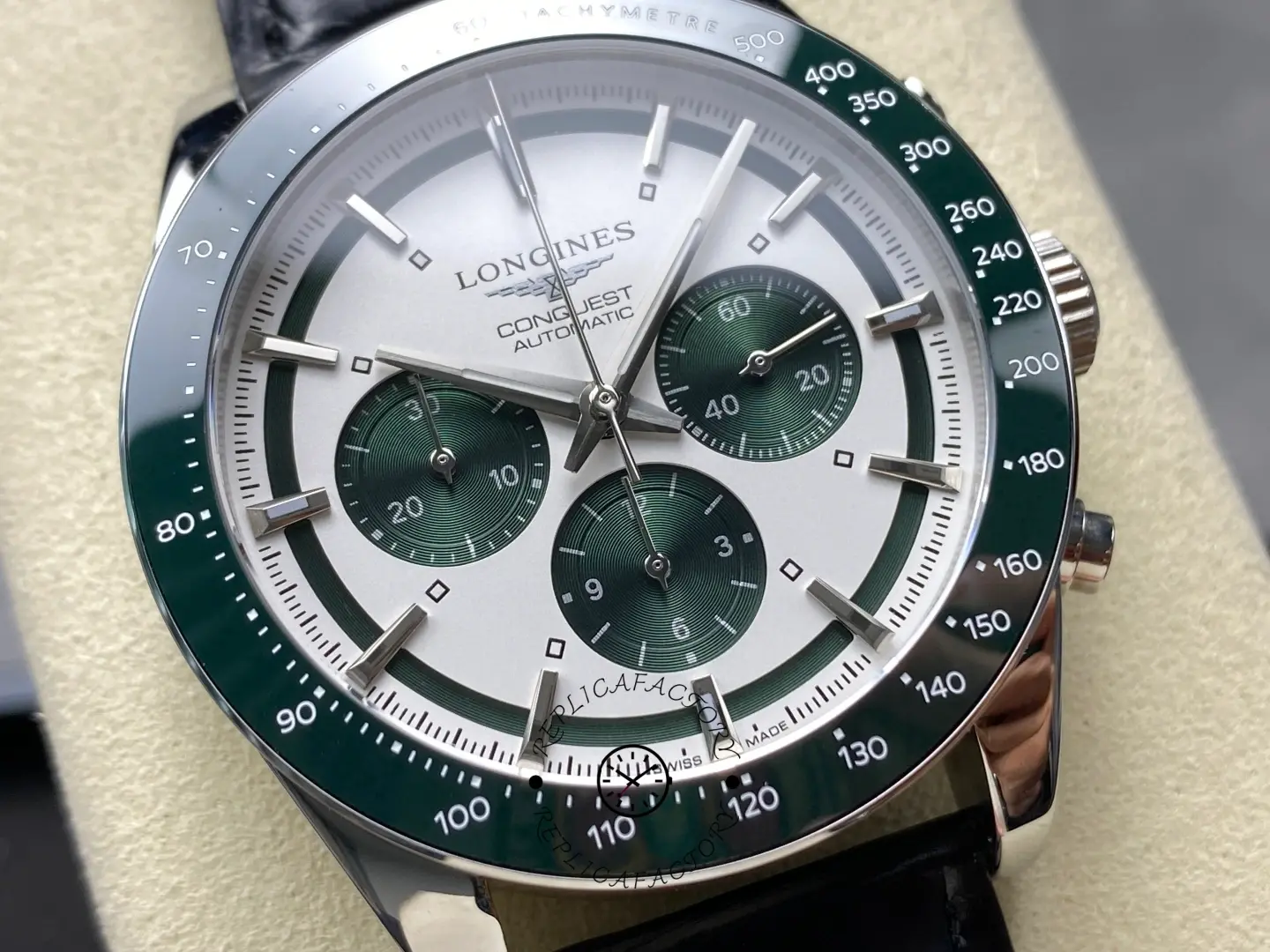 Longines Conquest Chronograph L3.835.4.02.6, close-up of silver dial with green subdials and green bezel.