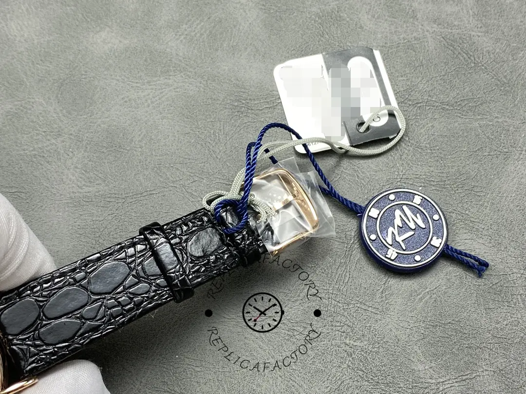 Strap buckle and hangtag of the Longines L4.787.8.11.4, black leather strap with branding.