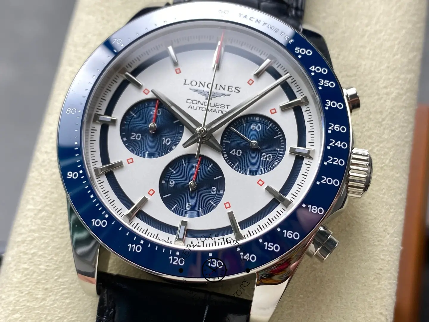Longines Conquest Chronograph L3.835.4.98.9, dial close-up showing blue subdials, red accents, and baton indices.