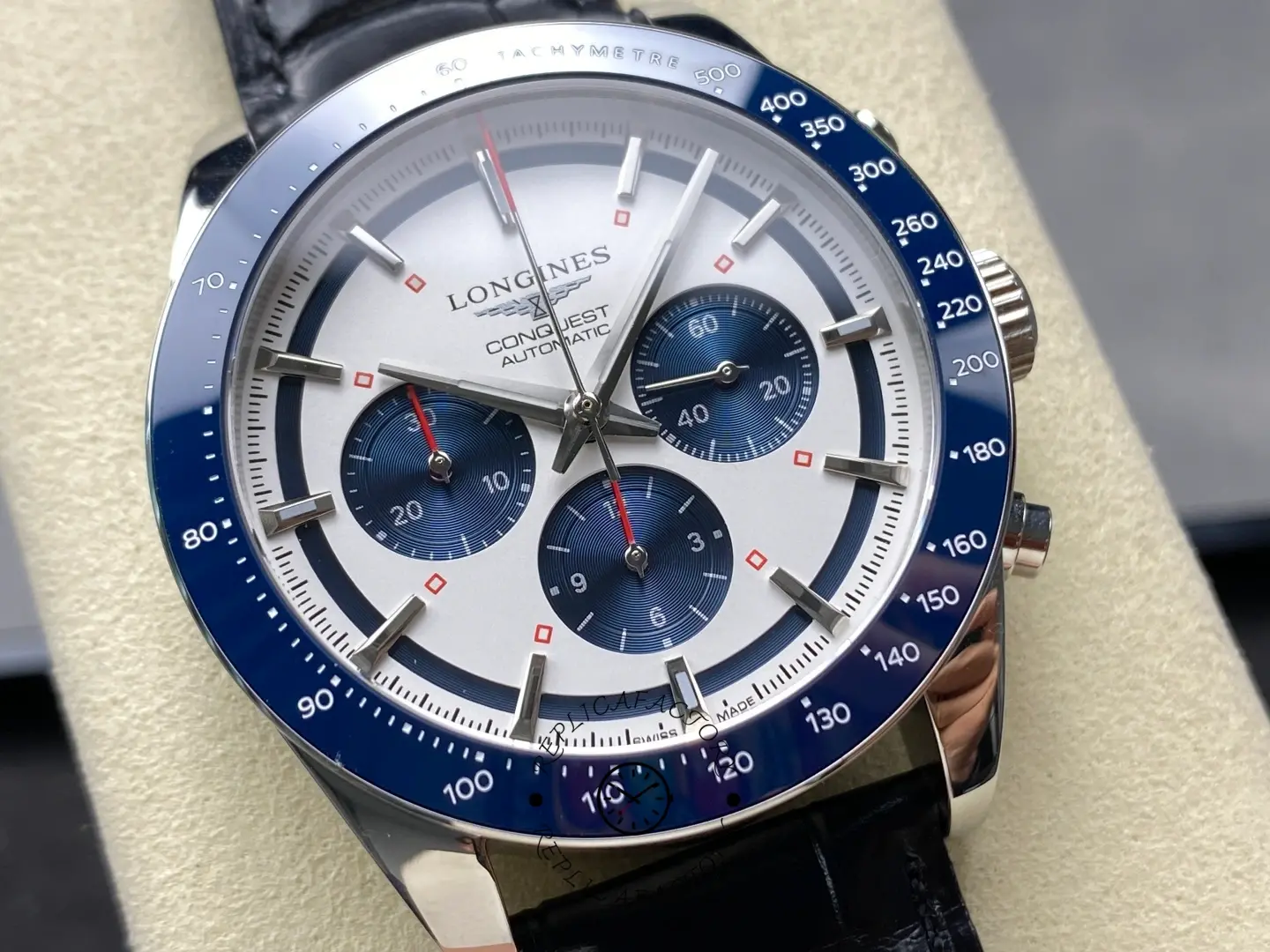 Longines Conquest Chronograph L3.835.4.98.9, close-up of silver dial with blue subdials and blue tachymeter bezel.