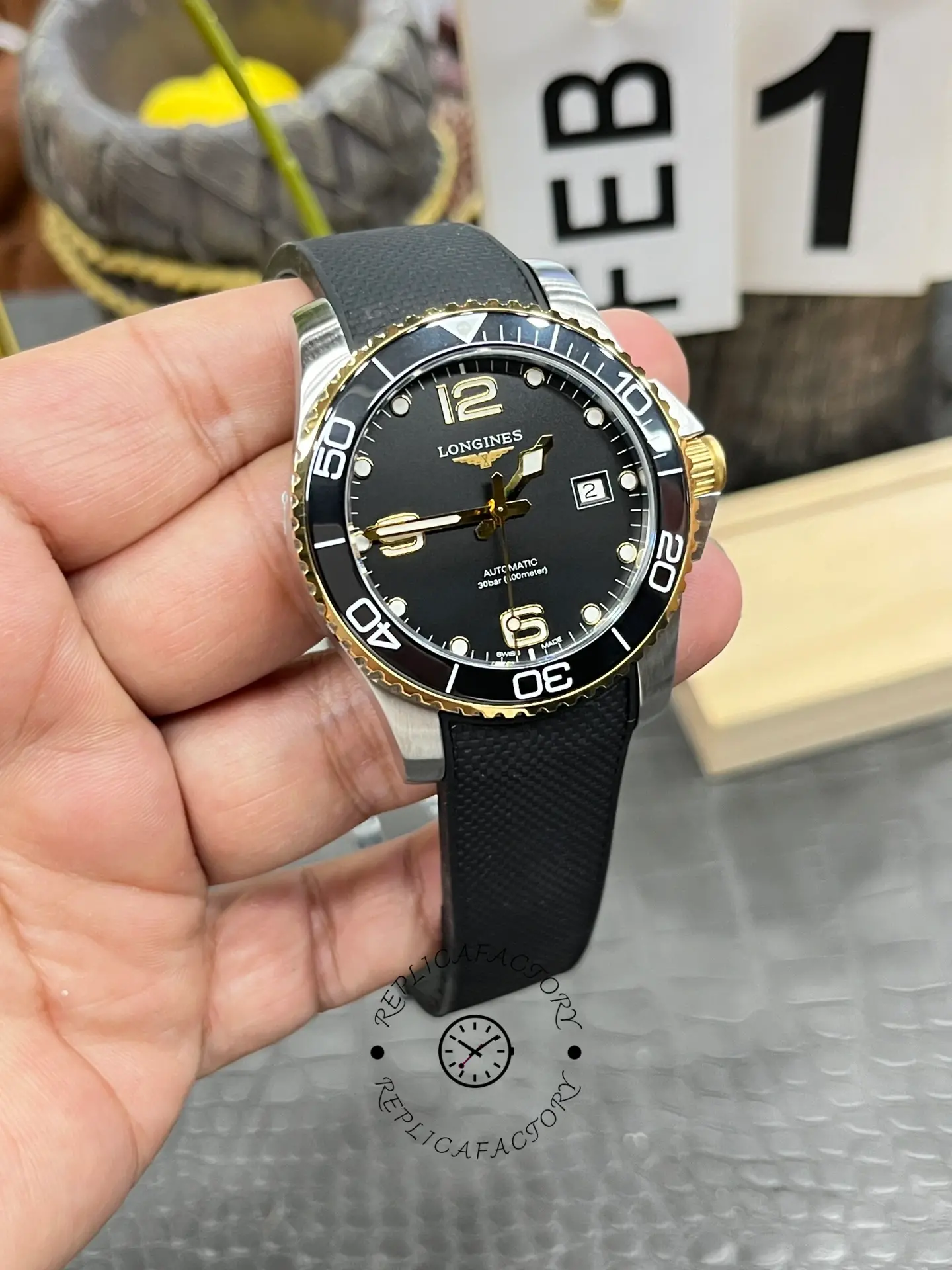 Close-up of Longines HydroConquest L3.781.3.56.9 dial, showing gold hands and indices.