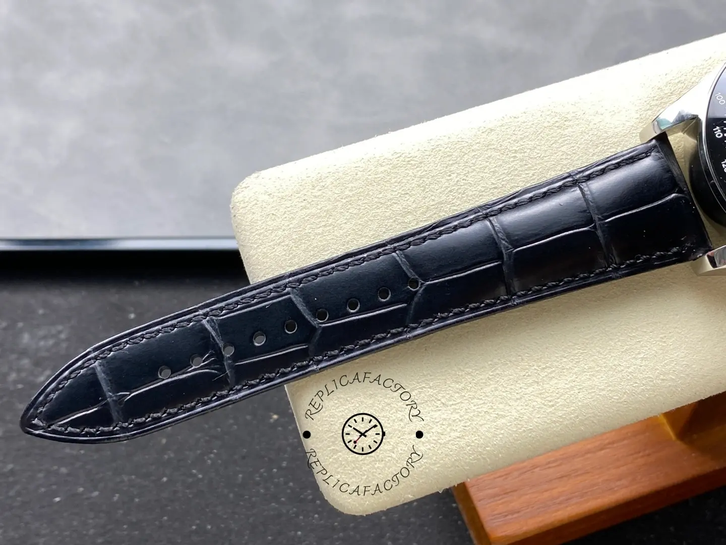 Strap detail of Longines Conquest L3.835.4.52.6 showing black leather texture and stitching.