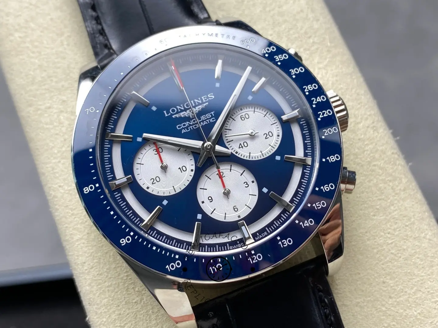 Detailed close-up of Longines Conquest L3.835.4.91.2 blue tachymeter bezel and chronograph hands.