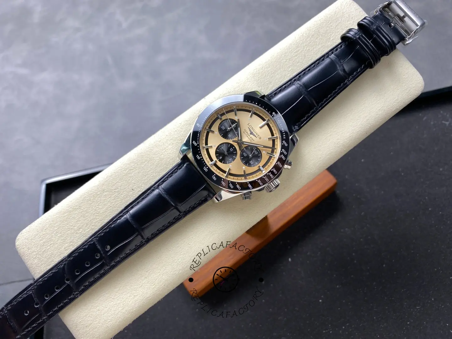 Longines L3.835.4.32.9 full watch on black leather strap, gold dial chronograph with tachymeter bezel.