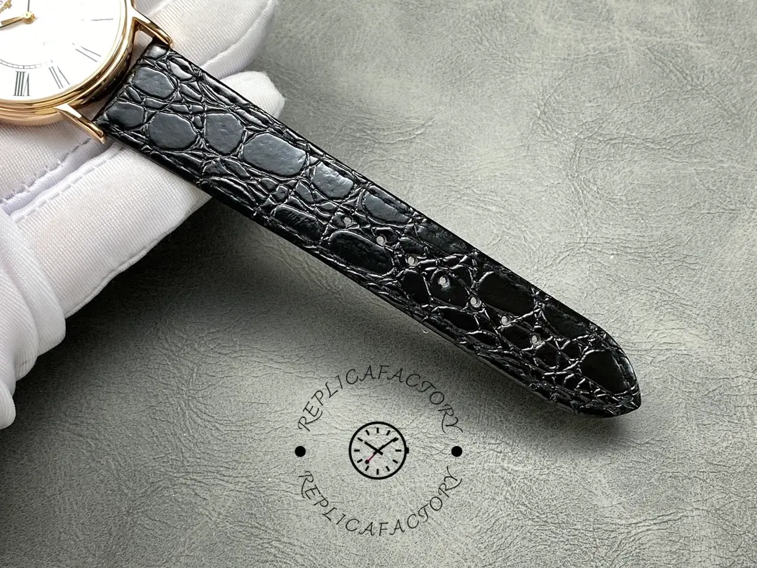 Leather strap tip of the Longines L4.787.8.11.4, black croc-embossed texture and stitching.