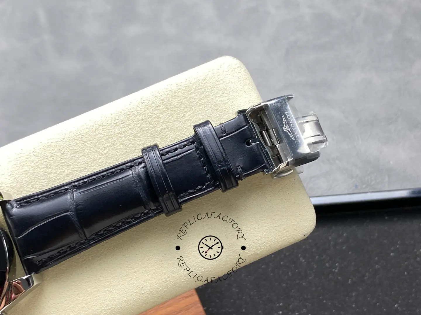 Longines Conquest L3.836.4.52.9 clasp close-up with engraved Longines logo.