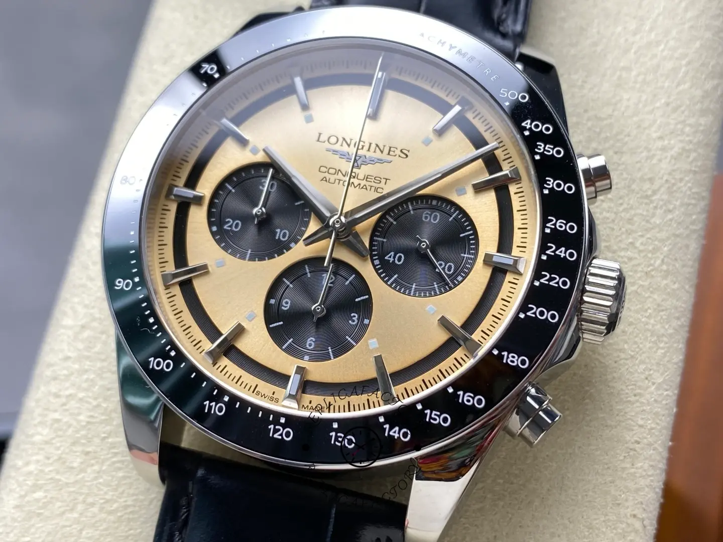 Longines L3.835.4.32.9 dial close-up, gold sunburst with black chronograph subdials and tachymeter bezel.