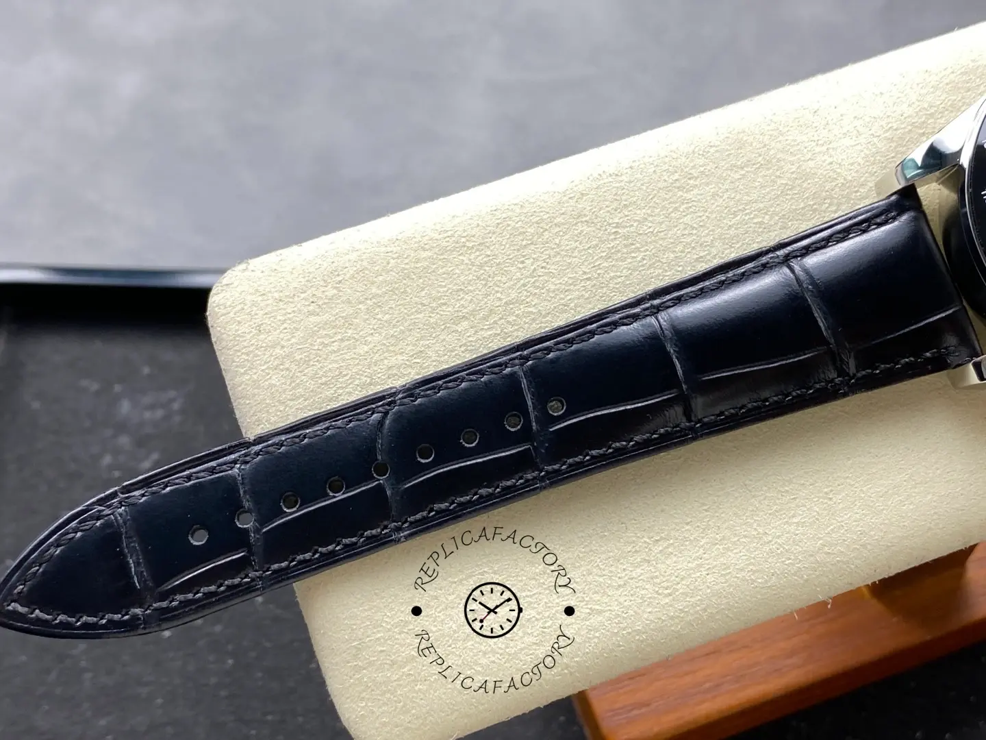 Longines L3.835.4.32.9 black leather strap tip with stitching and adjustment holes.