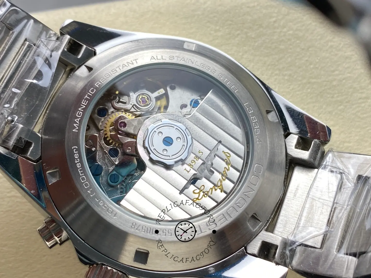 Longines Conquest Chronograph L3.835.4.98.6, exhibition caseback showing rotor and movement through clear crystal.