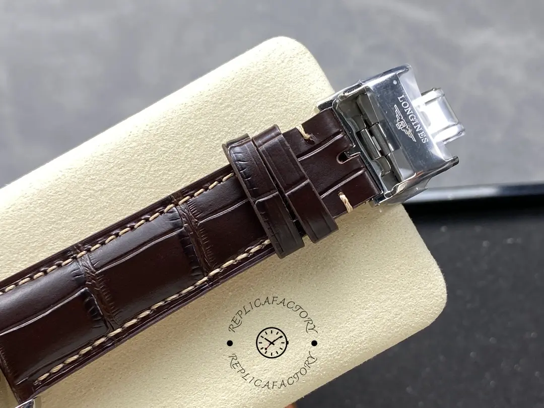 Longines L2.673.4.78.3 buckle close-up, engraved Longines clasp on brown leather strap.