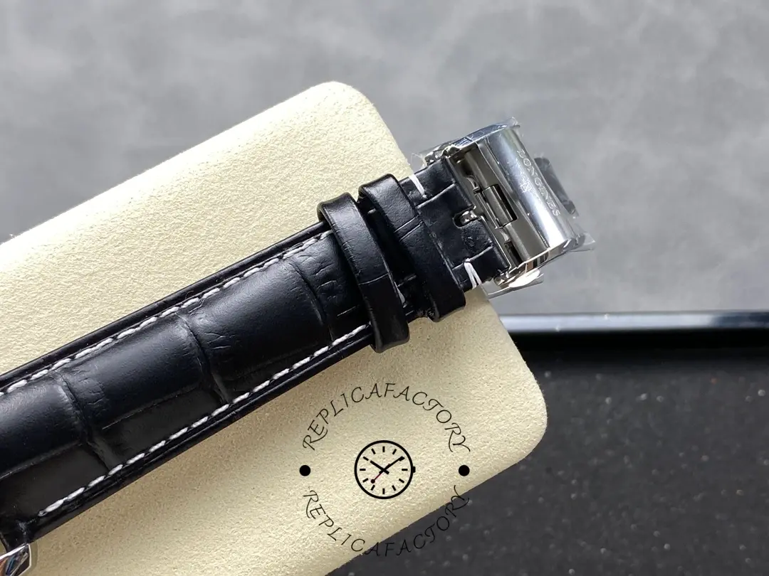 Clasp detail of Longines L2.673.4.78.3 showing the deployant buckle and black leather strap.