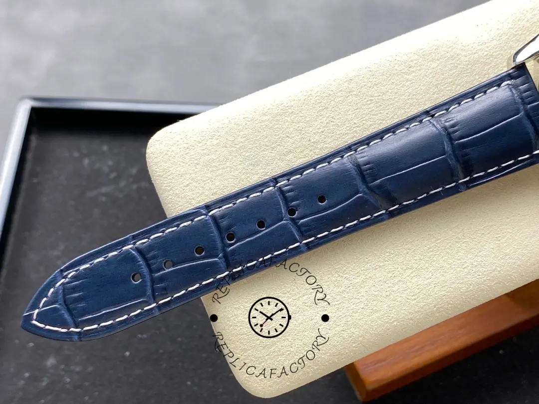 Blue leather strap holes detail for Longines Master Collection L2.673.4.92.0, with white stitching.