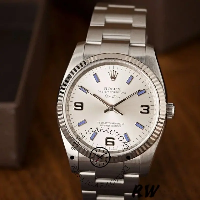 Rolex Air-King 114234, 34mm silver dial with blue hour markers, stainless steel bracelet, angled view.