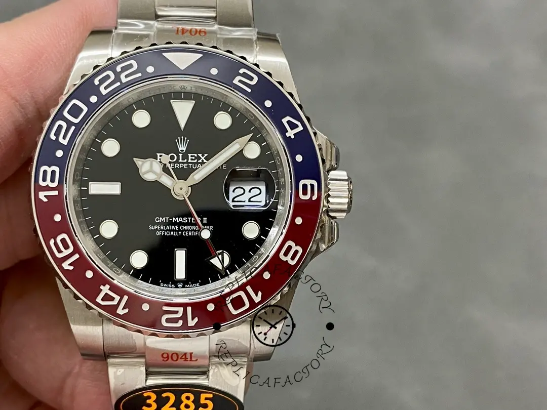 Handheld front view of the Rolex GMT-Master II 126710BLRO 0002, red-blue bezel visible.