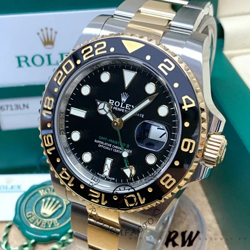 Close-up display of the Rolex GMT-Master II 116713LN with box and tags behind the watch.