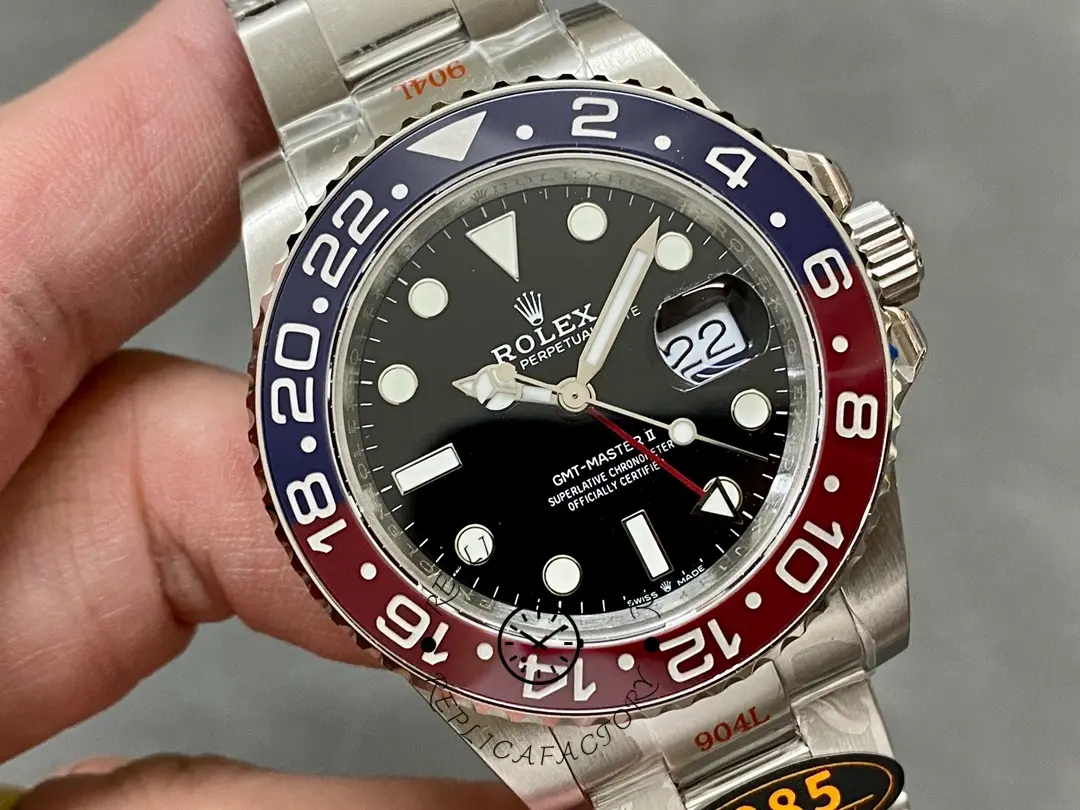 Handheld close-up of the Rolex GMT-Master II 126710BLRO 0002 showing dial and date window.