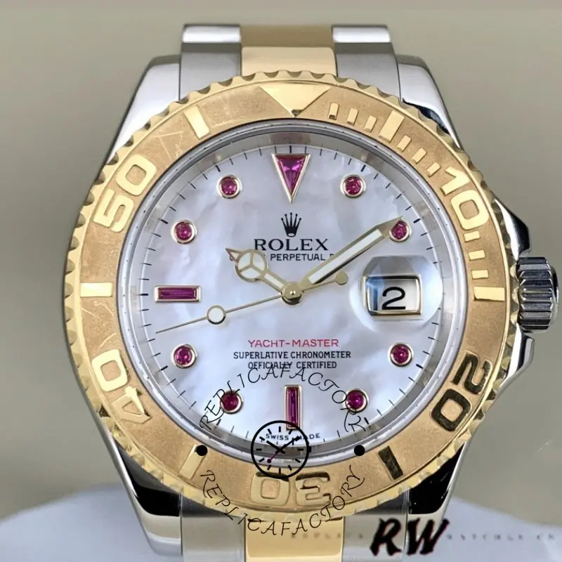 Close-up of Rolex Yacht-Master 16623 white MOP dial with red accents and gold bezel.