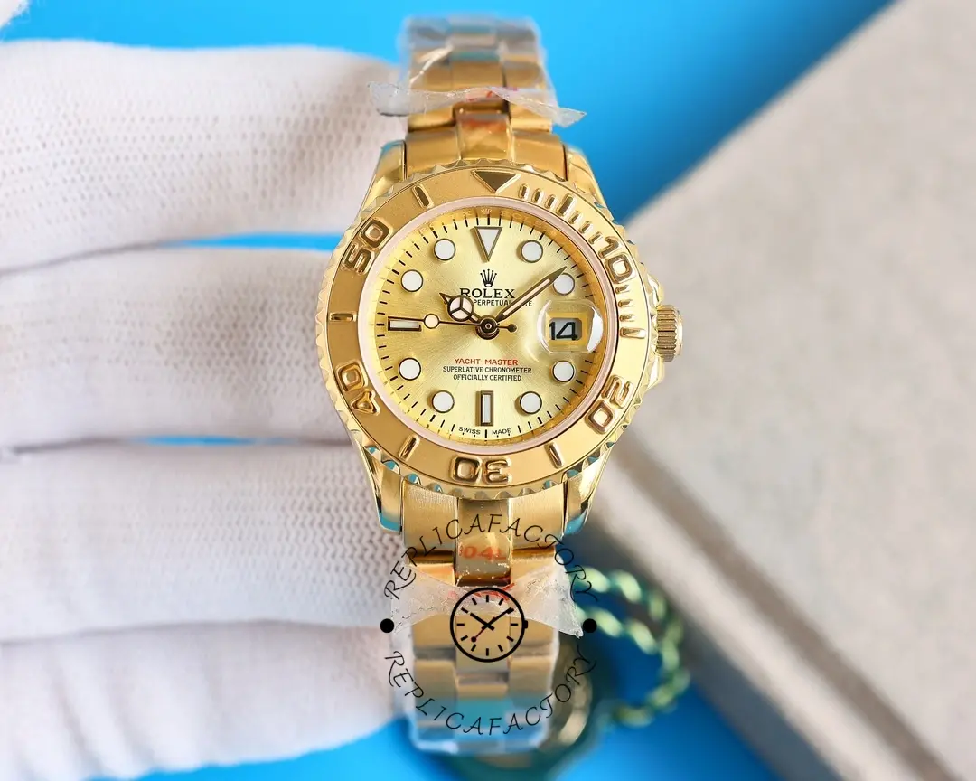 Glove-held front view of the Rolex Yacht-Master 169628 showing champagne dial and gold bezel.